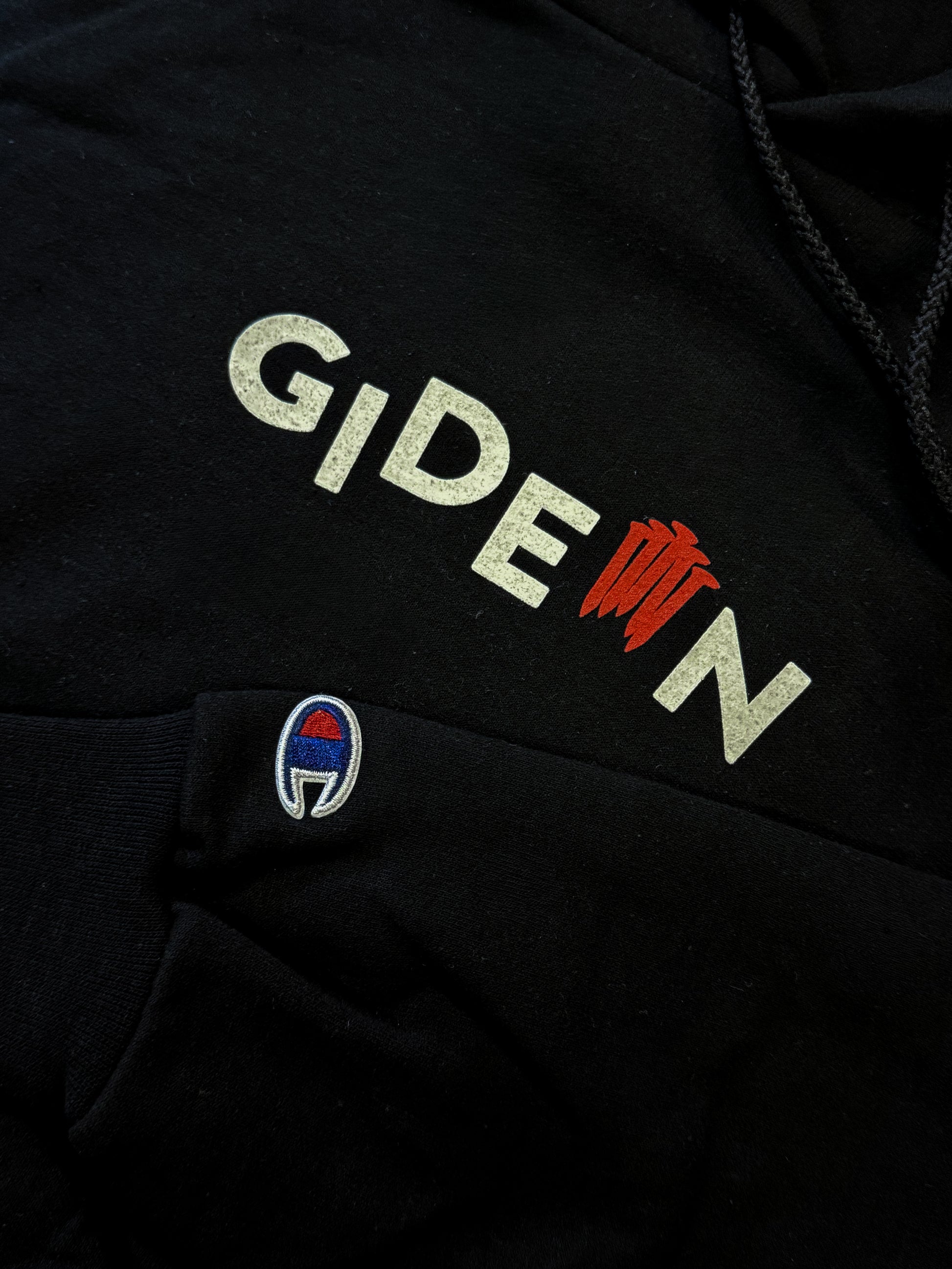 BLACK CHAMPION BRANDED HOODIE WITH WHITE GIDEON LOGO AND RED NAILS