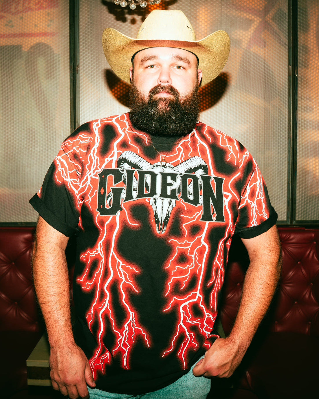 DANIEL MCWHORTER wearing a cowboy hat and a t-shirt with  RED lightning design and 'Gideon' text.
