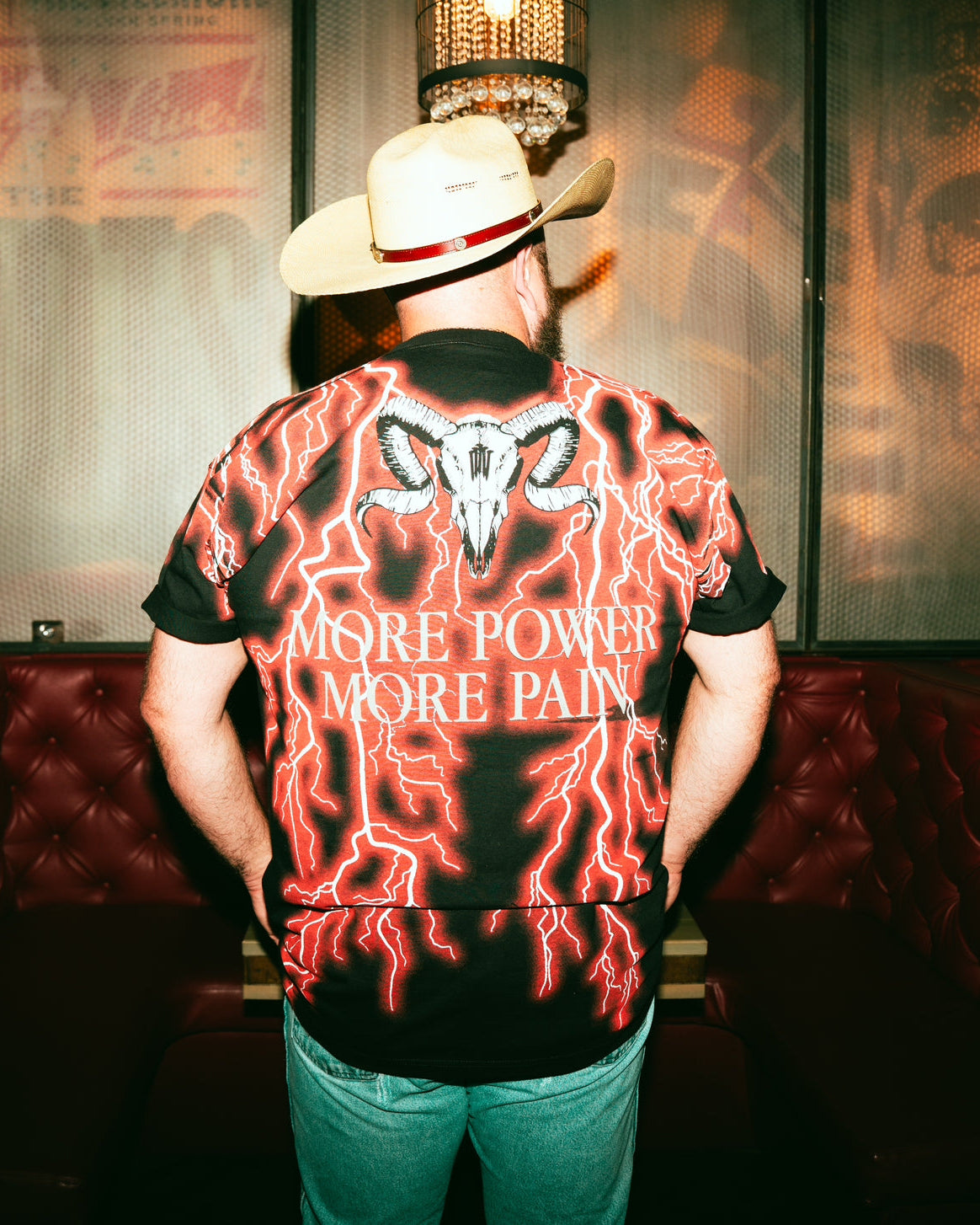 DANIEL MCWHORTER WEARING RED LIGHTINING T WITH TEXT MORE POWER MORE PAIN AND GHOST SKULL