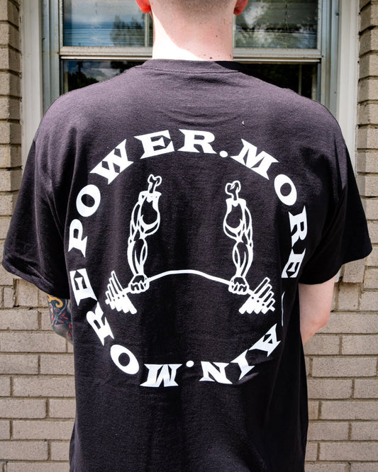 GIDEON BAND MERCHANDISE. BLACK T-SHIRT WITH WHITE PRINT. BACK PRINT WHITE MORE POWER. MORE PAIN. RIPPED OFF ARMS HOLDING BARBELL. 