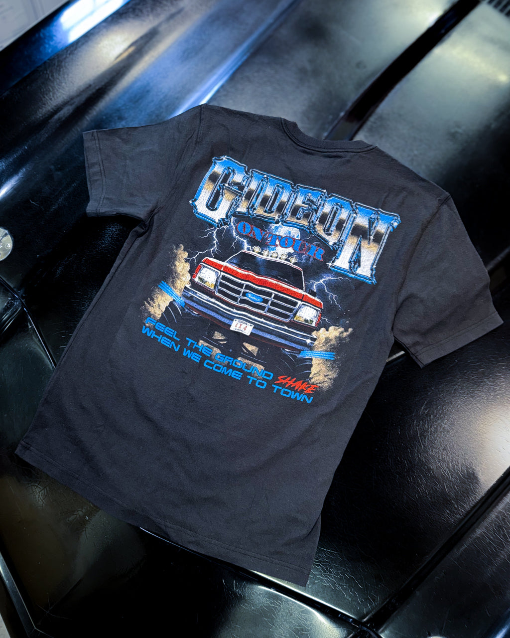 BACK PRINT OF GIDEON LOGO TRUCK AND IT SAYS FEEL THE GROUND SHAKE WHEN WE COME TO TOWN
