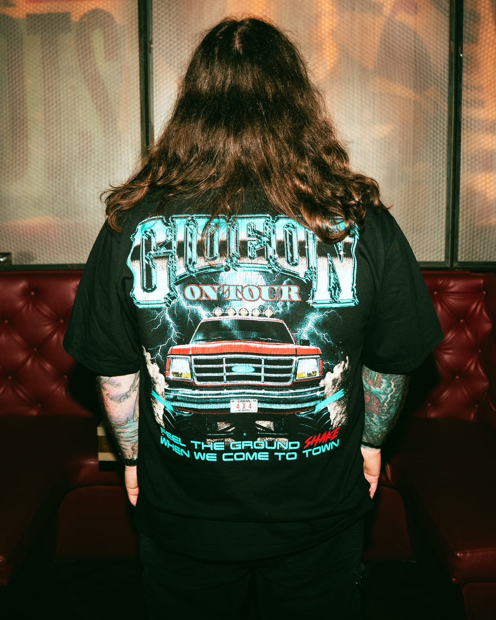 Person wearing a black t-shirt with graphic design and text  GIDEON 4X4 ON TOUR