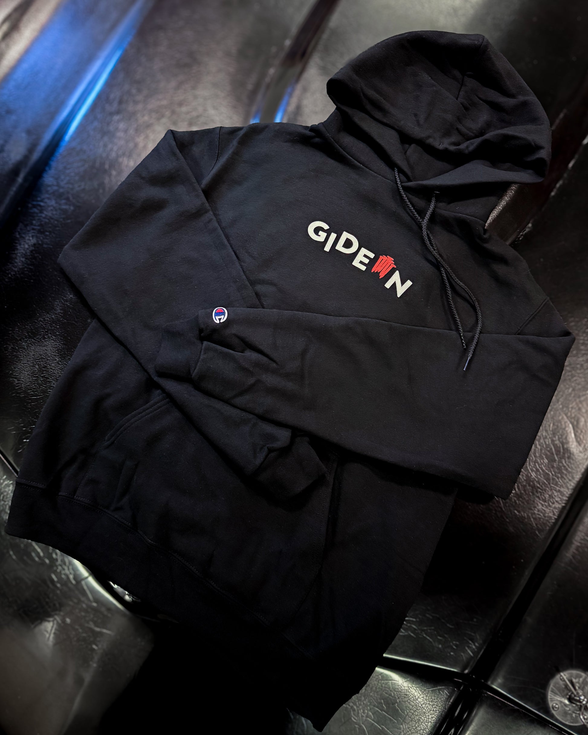 BLACK CHAMPION BRANDED HOODIE WITH WHITE GIDEON LOGO AND RED NAILS